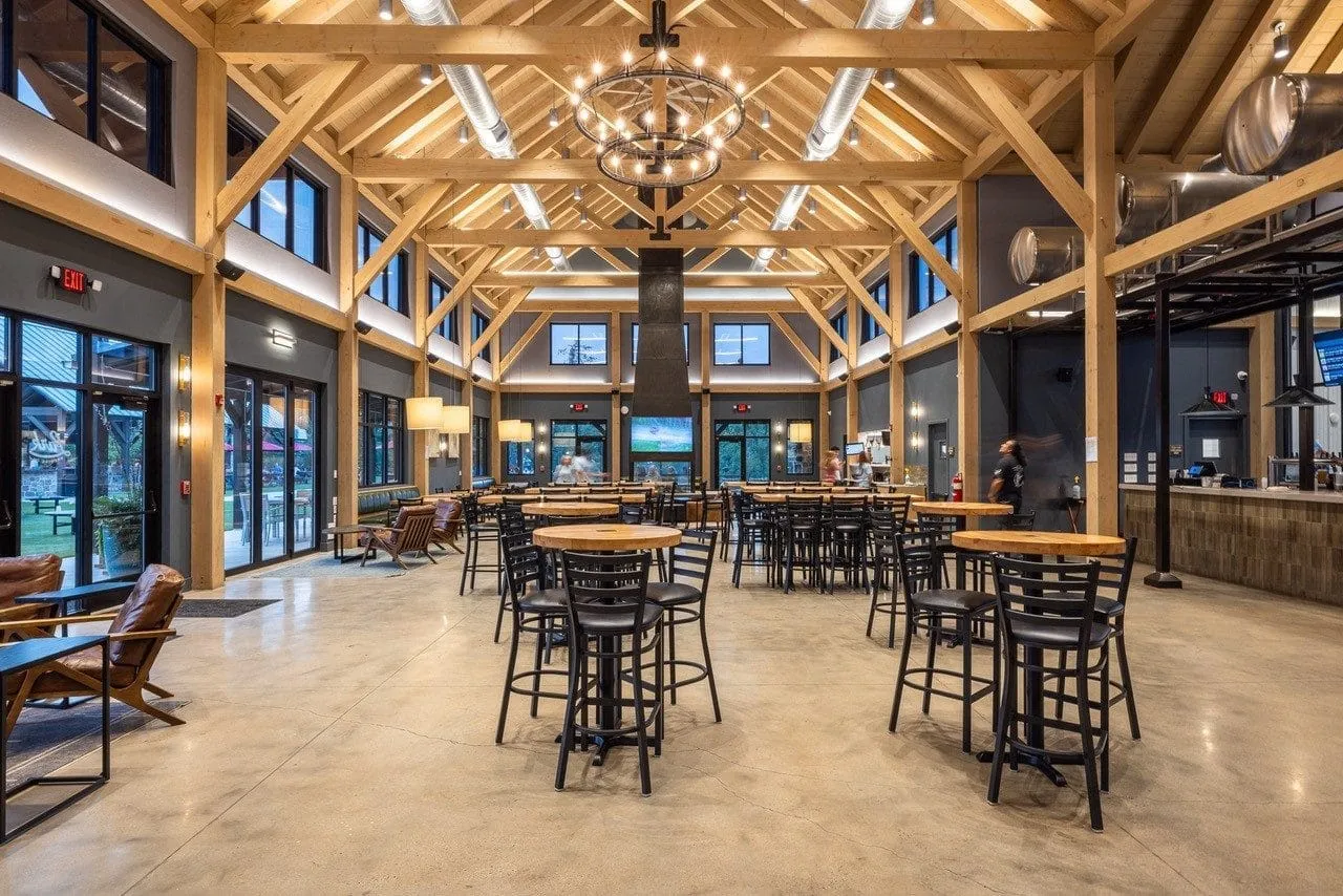Interior taproom at Lark Brewing with exposed heavy-timber trusses and bar seating