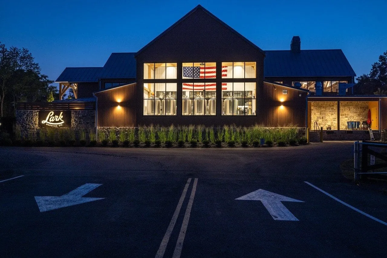 Lark Brewing at twilight — illuminated timber-frame facade in Aldie, Virginia