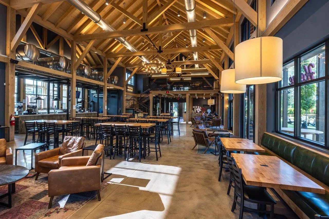 Lounge with leather seating and timber-frame ceiling at Lark Brewing