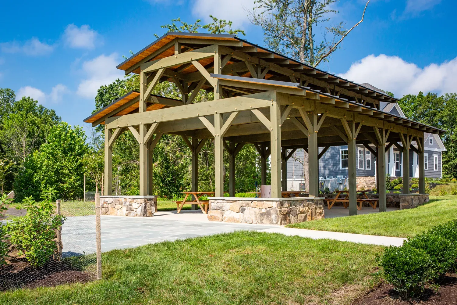 Willowsford Community Pavilion heavy timber frame structure with stone fireplace overlooking pond in Ashburn, VA